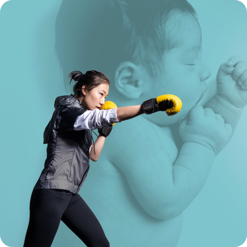Woman boxing in front of large baby image on teal background