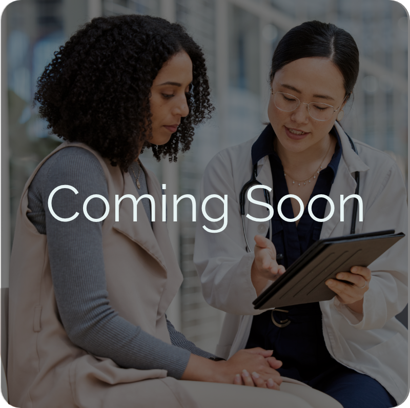 Coming Soon overlay on doctor counseling patient with tablet