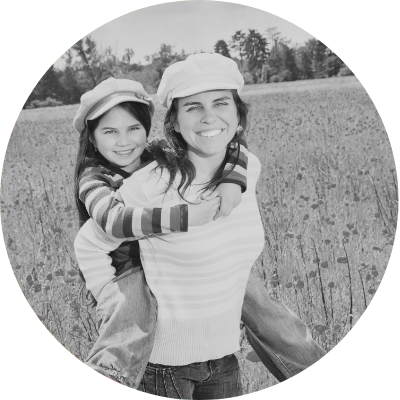 Close-up of mother embracing child, black and white