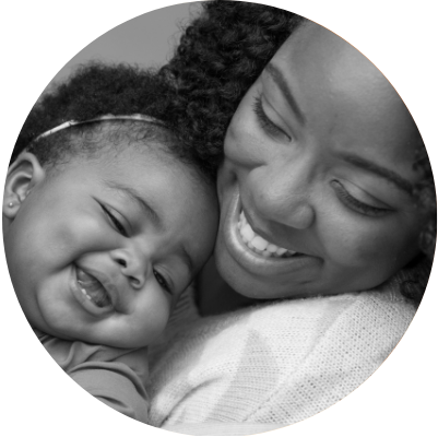 Mother holding young child in a flower field